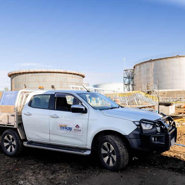 Gordon McKay ute in front of tank where industrial electricians performed electrical maintenance in Melbourne