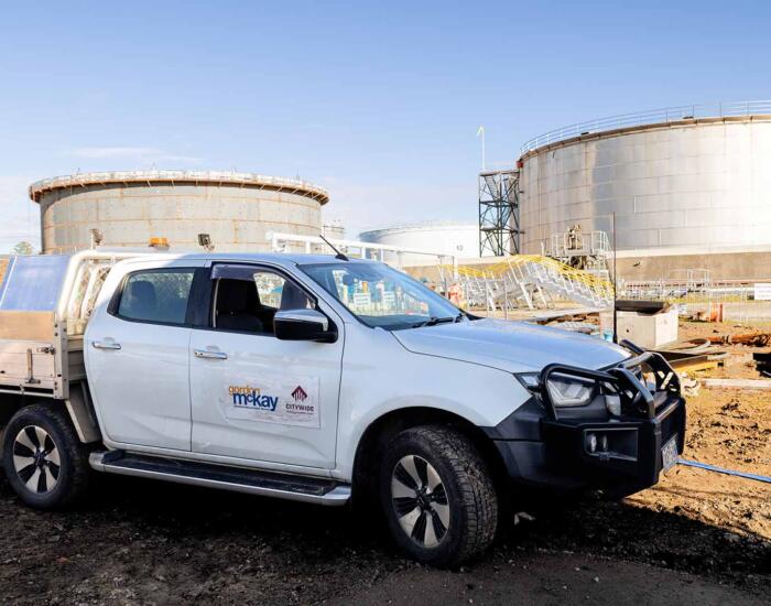 Gordon McKay ute in front of tank where industrial electricians performed electrical maintenance in Melbourne